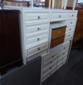 A CREAM FINISH KNEEHOLE DRESSING TABLE AND MATCHING CHEST OF EIGHT DRAWERS AND THE DRESSING STOOL