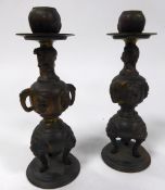 PAIR OF ORIENTAL GILT BRONZE CANDLESTICKS, each modelled with panels containing animals and raised