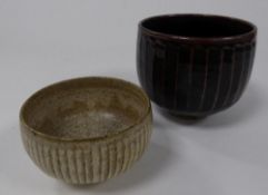 TWO STUDIO POTTERY FLUTED BOWLS BY DAVID LEACH, of steep sided, footed form, one with temmoku glaze,