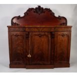 VICTORIAN CARVED AND FIGURED MAHOGANY BREAKFRONT SIDEBOARD, the shaped back outlined with applied,