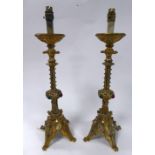 PAIR OF LATE VICTORIAN GOTHIC REVIVAL COLOURED GLASS MOUNTED GILT METAL CANDLESTICKS, converted to