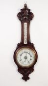 T.L. AINSLEY, CARDIFF, EDWARDIAN CARVED OAK ANEROID BAROMETER, the 8? dial beneath a removable