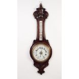 T.L. AINSLEY, CARDIFF, EDWARDIAN CARVED OAK ANEROID BAROMETER, the 8? dial beneath a removable