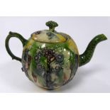 EIGHTEENTH CENTURY WHEELDON MOULDED POTTERY TEAPOT AND COVER, of bullet form with leaf moulded