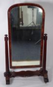 EARLY NINETEENTH CENTURY ROSEWOOD CHEVAL DRESSING MIRROR, the plate housed in an arch topped