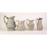 FOUR SAGE GREEN GLAZED FOLIATE MOULDED POTTERY JUGS, comprising THREE PROBABLY RIDGWAY & ABINGTON