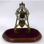 LATE VICTORIAN BRASS SKELETON CLOCK UNDER GLASS DOME, the 4 ¼? enamelled Roman chapter ring