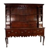 LATE EIGHTEENTH CENTURY OAK DRESSER, the enclosed plate rack with moulded cornice and fret cut apron