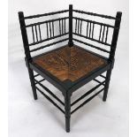 AFTER A DESIGN BY WILLIAM MORRIS, BAMBOO PATTERN EBONISED CORNER CHAIR, of typical form with spindle