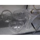 A LARGE CUT GLASS CIRCULAR BOWL RAISED ON THREE SCROLL FEET, 11 ½? DIAMETER; A CUT GLASS BASKET