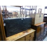 A BLACK PAINTED TOOL TRUNK, HAVING FITTED DRAWERS AND DROP FRONT, CONTAINING A SELECTION OF OLD