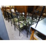 A WROUGHT IRON DINING TABLE, WITH GLASS TOP AND FOUR WROUGHT IRON DINING CHAIRS (5)