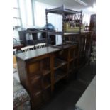 AN OAK SIDE-BY-SIDE DISPLAY CABINET WITH CENTRE SHELVES AND A TEA TROLLEY WITH BARLEY TWIST LEGS (2)