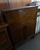 A SECRETAIRE CHEST/CUPBOARD, HAVING DROP-DOWN TOP SECTION FITTED WITH PIGEON HOLES, THE LOWER