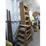 A PAIR OF LARGE WOODEN EASELS (240cm high), A SET OF 10 RUNG WOODEN STEP LADDERS AND A SET OF FIVE