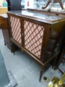 A REPRODUCTION TWO DOOR DRINKS CABINET, DOORS HAVING LATTICE WORK AND RAISED ON TURNED LEGS