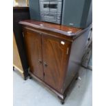A REPRODUCTION MAHOGANY MEDIA CENTRE CABINET WITH FOLDING HINGE DOORS OVER FALL FRONT COMPARTMENT