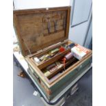 A FITTED WOODEN TOOL TRUNK CONTAINING VARIOUS TOOLS AND FOUR OLD OIL CANS