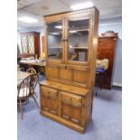 ERCOL ?GOLDEN HARVEST? DISPLAY/ DRINKS CABINET AND SET OF SIX WHEEL BACK DINING CHAIRS, (7)