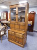 ERCOL ?GOLDEN HARVEST? DISPLAY/ DRINKS CABINET AND SET OF SIX WHEEL BACK DINING CHAIRS, (7)