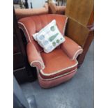 A SMALL SEMI WINGED LOUNGE CHAIR, IN WINE RED FABRIC