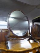 A MAHOGANY OVAL SKELETAL CHEVAL SWING TOILET MIRROR