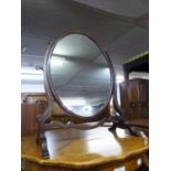 A MAHOGANY OVAL SKELETAL CHEVAL SWING TOILET MIRROR