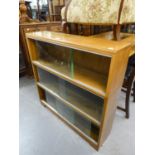 A POSSIBLY 'MINTY' OAK THREE TIER SECTIONAL BOOKCASE WITH GLASS SLIDING DOORS