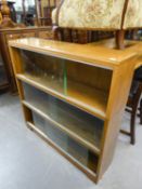 A POSSIBLY 'MINTY' OAK THREE TIER SECTIONAL BOOKCASE WITH GLASS SLIDING DOORS