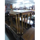 A NEST OF THREE FIGURED WALNUT OBLONG COFFEE TABLES