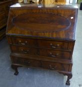 GOOD QUALITY MAHOGANY CARVED BUREAU, HAVING THREE LONG DRAWERS ON CABRIOLE CLAW AND BALL FEET WITH