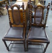 A SET OF FOUR CAROLEAN STYLE OAK DINING CHAIRS, WITH CANED OVAL SPLAT BACKS WITH SPIRAL SIDE COLUMNS