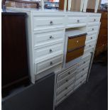 A CREAM FINISH KNEEHOLE DRESSING TABLE AND MATCHING CHEST OF EIGHT DRAWERS AND THE DRESSING STOOL
