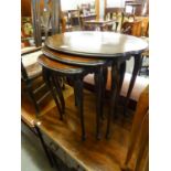A NEST OF THREE QUARTERED MAHOGANY OVAL COFFEE TABLES