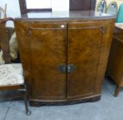 CAROLEAN STYLE FIGURED WALNUT WOOD BOW FRONTED BAR/COCKTAIL CABINET, THE TOP FOLDING OUT FROM THE