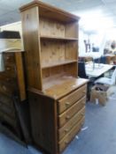 A MODERN PINE CHEST OF FOUR LONG DRAWERS, SURMOUNTED BY THREE TIER OPEN SHELVING