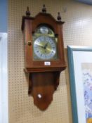 A MAHOGANY CASED WALL CLOCK, WITH SPRING DRIVEN MOVEMENT, ARCHED BRASS AND SILVERED DIAL, WITH