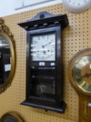 AN OAK CASED WELLINGTON WALL CLOCK