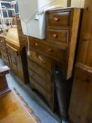 A LIGHT OAK CHEST OF FOUR LONG DRAWERS AND THE SUNK CENTRE DRESSING TABLE WITH FRAMELESS MIRROR