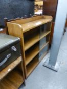 AN OAK THREE TIER BOOKCASE HAVING GLASS SLIDING DOORS AND AN OAK TWO TIER OCCASIONAL TABLE (2)