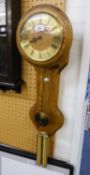 AN OAK DROP DIAL WALL CLOCK WITH TWO BRASS SIMULATED WEIGHTS AND PENDULUM