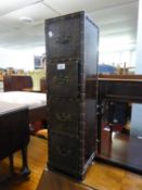 A MIDDLE EASTERN SMALL, NARROW CHEST OF FOUR DRAWERS COVERED IN BROWN TOOLED LEATHER WITH METAL