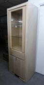 GOODO QUALITY LIGHT OAK TALL CABINET, having a glass door above a drawer and a panel door (purchased