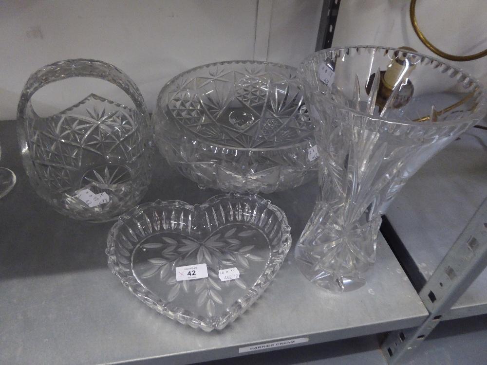 A LARGE CUT GLASS CIRCULAR BOWL RAISED ON THREE SCROLL FEET, 11 ½? DIAMETER; A CUT GLASS BASKET