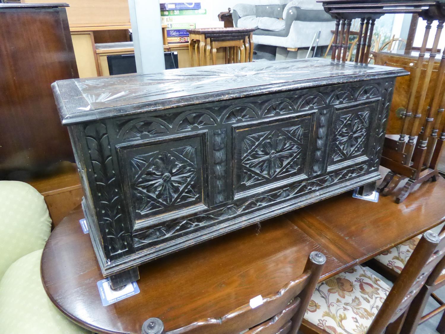 A CARVED DARK OAK BLANKET CHEST