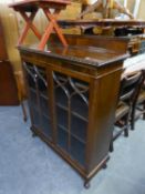 CHIPPENDALE STYLE MAHOGANY SMALL BOOKCASE WITH LEDGE BACK, GADROON CARVED EDGES, TWO ASTRAGAL GLAZED