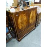 A REPRODUCTION MAHOGANY T.V. CABINET (99cm high x 94cm wide x 55cm deep)