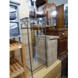 A WROUGHT IRON LAMP TABLE WITH GLASS TOP AND THE TABLE LAMP AND SHADE AND A LINEN BASKET