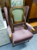 A WINGED FIRESIDE ARMCHAIR, UPHOLSTERED IN PINK VELVET