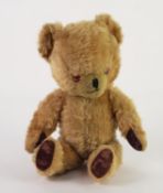 MID TWENTIETH CENTURY BLOND PLUSH TEDDY BEAR, wool filled with bells sewn into the ears and with